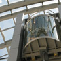 Panoramic lift with semicircular cab made by glass and stainless steel elements